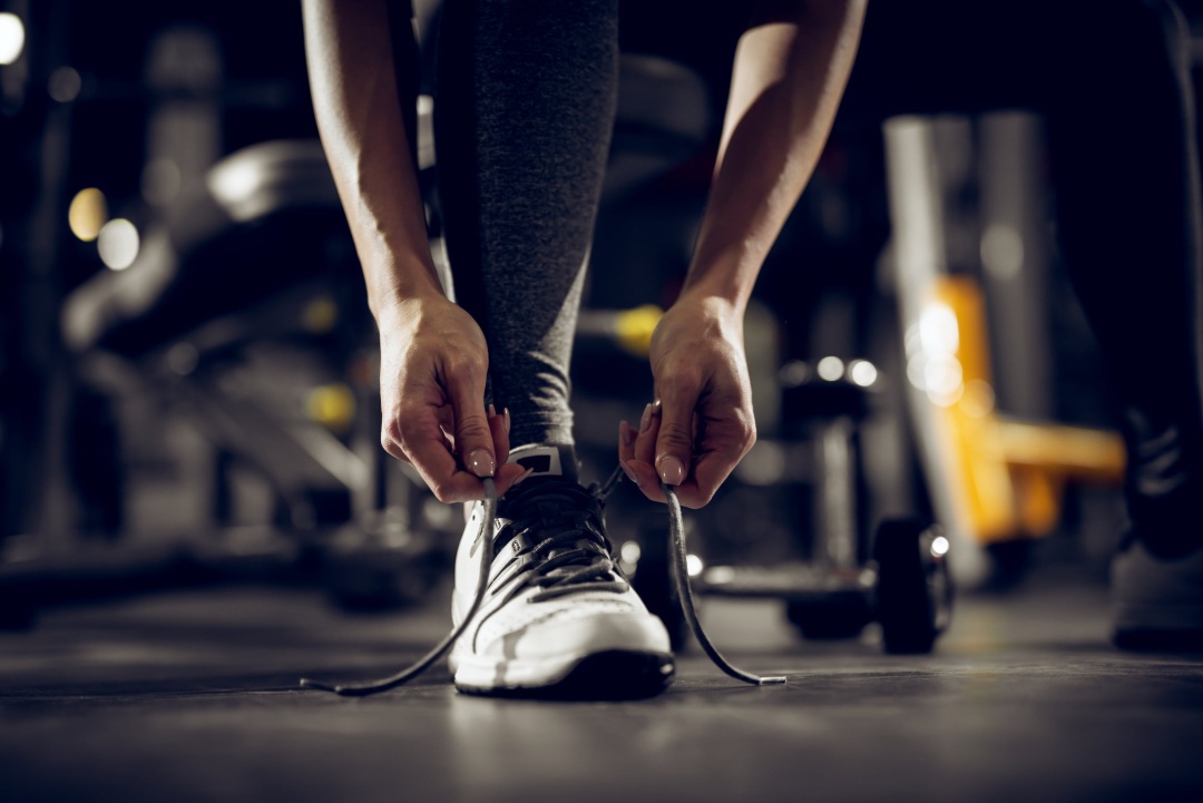 Woman tying her shoe preparing for exercise