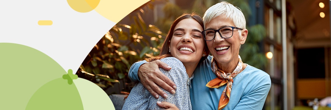 Portrait of a young and an older women hugging each other
