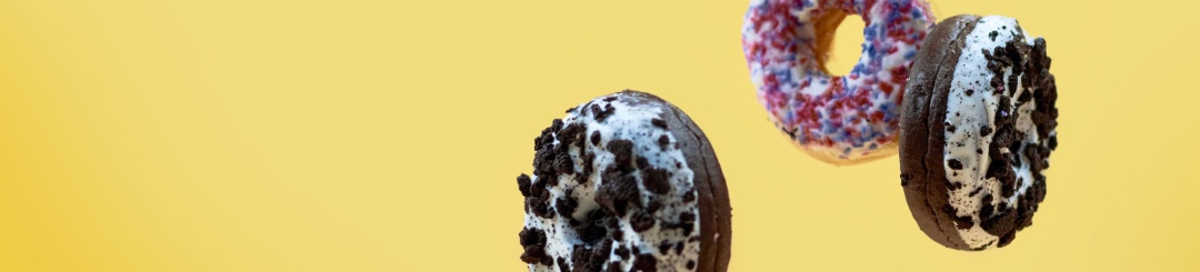 Donuts floating in front of a yellow background