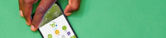 Hand holding a phone with mySugr CGM graph on the screen